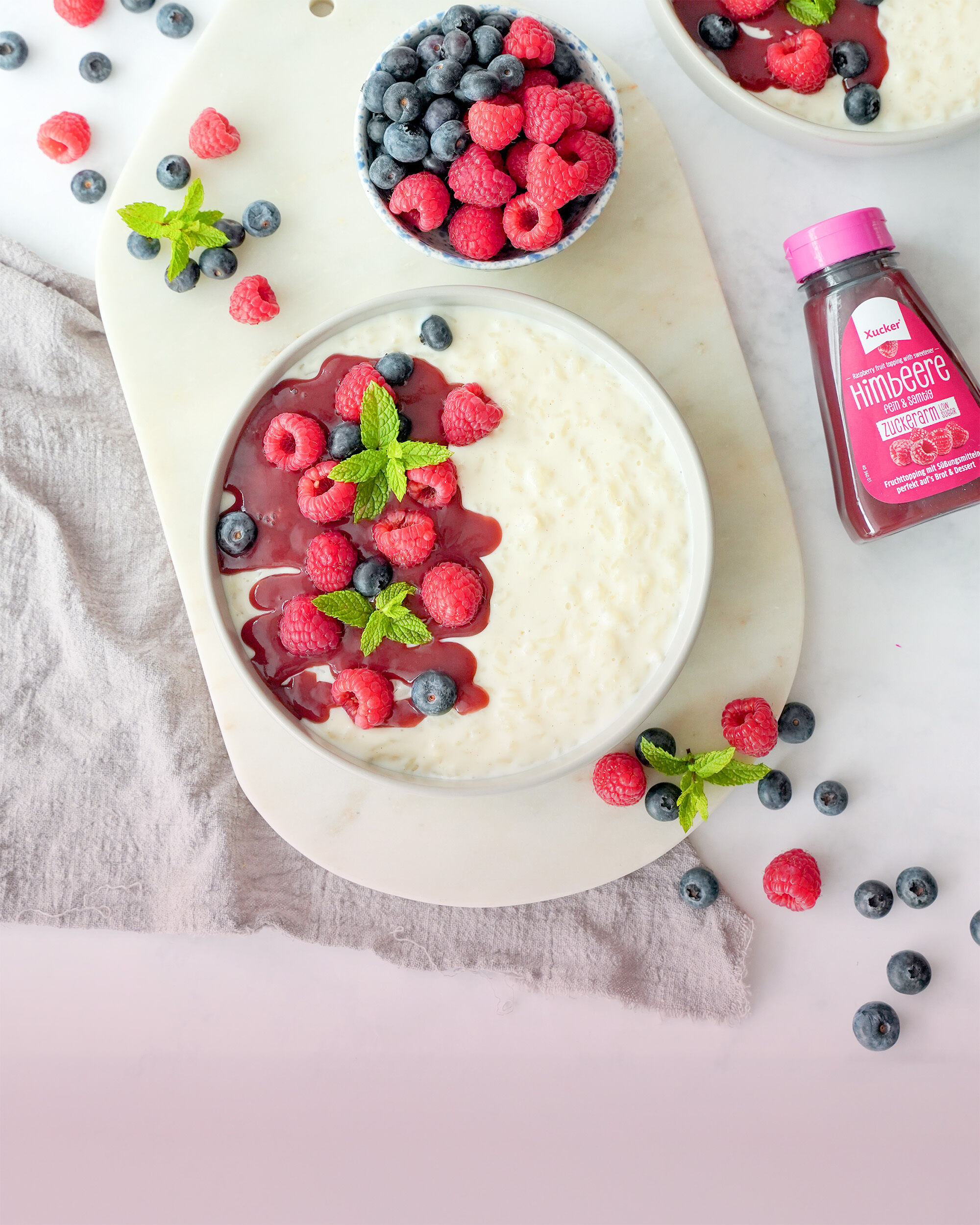 Milchreis mit Beeren angerichtet und Fruchttopping von Xucker ohne zugesetzten Zucker